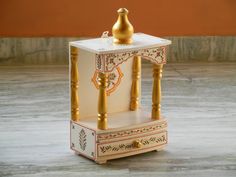 a small white and gold shrine on the floor