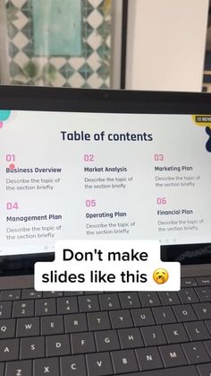 a laptop computer sitting on top of a desk with the words don't make slides like this