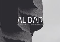 the words aldar written in arabic on top of a tall building with curved windows