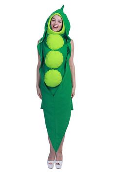 a woman wearing a green pea costume with two peas on it's back and the tail