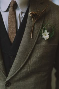 a man in a suit with a boutonniere on his lapel