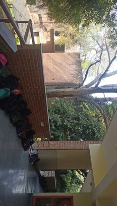 there are many bags and purses on the floor next to each other in front of a building