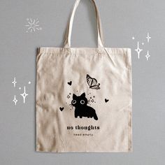 "☆An adorable cat tote bag made for all silly kitty lovers! :3 ☆Complete your look with the \"No Thoughts, Head Empty\" Black Cat Tote Bag! An artsy and adorable tote that adds a cozy flare to your outings. This sleek 100% cotton, canvas tote features a silly black cat design that's both funny and cute, making it the perfect aesthetic accessory. With its roomy interior and sturdy straps, it's not just about looks - it's a functional and fashionable must-have for carrying all your essentials.  ☆D Aesthetic Totebag Design, Tote Bag Cat Design, Cat Tote Bag Design, Design Totebag Aesthetic, Tote Bag Design Paint, Tote Bag Design Aesthetic, Black Tote Bag Design, Black Tote Bag Aesthetic