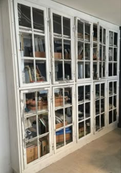 an old windowed bookcase in the corner of a room