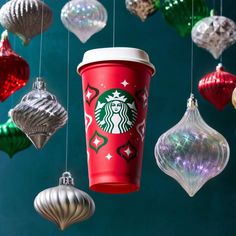 starbucks coffee cup hanging from strings with christmas ornaments