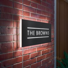 the brown's restaurant sign on a brick wall next to a potted plant