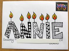 an artistic birthday card with candles and the word name anne written in bold black ink