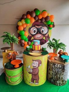 a table topped with lots of balloons and decorations