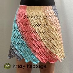 a woman is wearing a multicolored skirt with crochet on the bottom