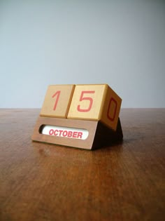 a wooden calendar sitting on top of a table