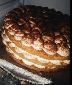 a cake with white frosting and brown icing