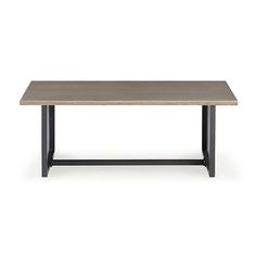 a wooden table sitting on top of a white floor next to a black metal frame