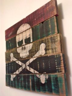 a wooden sign with a skull and crossbones painted on it