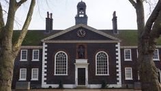 an old brick building with a clock on the front