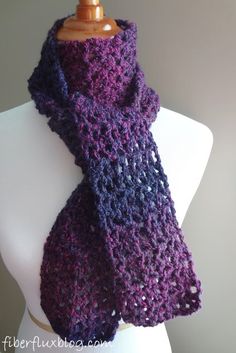 a purple and black scarf is on a mannequin