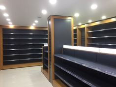 empty shelves in a store with lights on