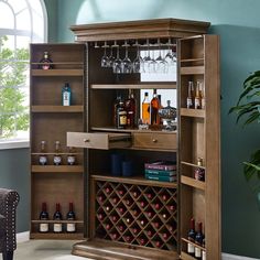 a living room with a chair and a wine rack in the corner next to a potted plant