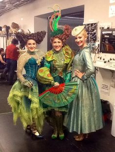 three women dressed in costume posing for the camera