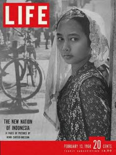 an old magazine cover with a young woman wearing a veil on her head and bicycle in the background