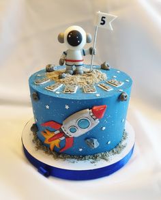 a birthday cake with an astronaut on top