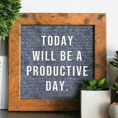 there is a sign that says today will be a productive day next to some potted plants