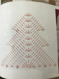 a white paper with red dots on it and a triangle in the middle that has been cut out