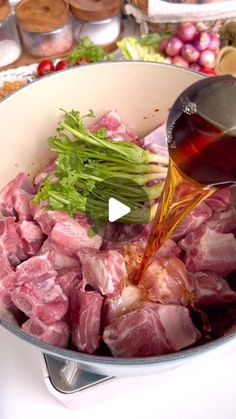 a pot filled with meat and sauce being poured into it