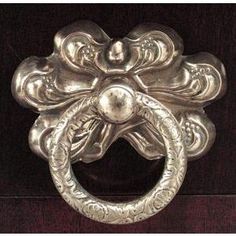 an ornate metal door handle on a wooden door