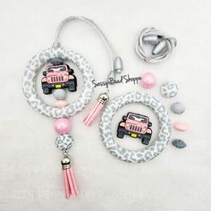 the pink jeep charm is on display next to its accessories