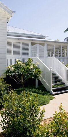 a white house with stairs leading up to it