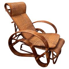 a wooden rocking chair with wicker seat and footrests on an isolated white background