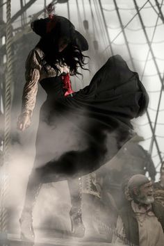 a woman dressed as a pirate jumping on a ship