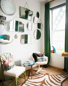 a living room filled with furniture and mirrors