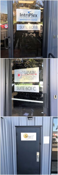 the front door of a building with three different signs on it's glass doors