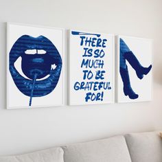 three paintings hanging on the wall in a living room with white furniture and blue accents