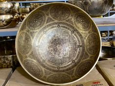 a large metal bowl sitting on top of a table