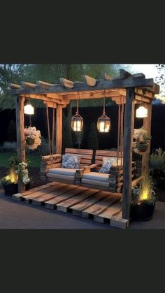 an outdoor swing bed made out of pallet wood with lights hanging from the ceiling