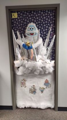 the door to an office decorated with frosting and paper mache characters, stars and clouds