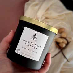 a hand holding a jar of hazelnut coffee