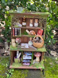 an old wooden shelf filled with books and other items