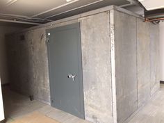 an empty room with two steel doors on the wall