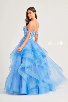 Make a statement in the captivating Ellie Wilde EW35084 ball gown. Showcasing an endearing off-shoulder neckline with a plunging, sheer inset feature, this dress is stunning. The mid-open back, secured by a zipper for a polished finish, adds allure. The top also exhibits wonderful floral appliques, allowing you to look remarkably charming. The glittery skirt boasts majestic ruffle designs, elevating the charm of this full-length attire. Get ready for a perfect and fantastic evening in this mesme Off Shoulder Ball Gown, Tiered Tulle Skirt, Gown For Prom, Ellie Wilde, Sherri Hill Prom Dresses, Prom Ball Gown, Plus Size Party Dresses, Lace Prom Dress, Bodice Dress