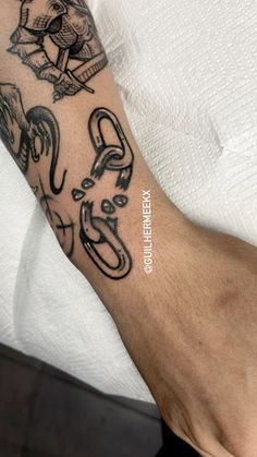 a man's arm with tattoos on it and the word love written in black ink