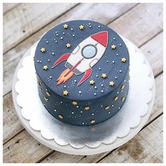 a blue cake with a rocket on top