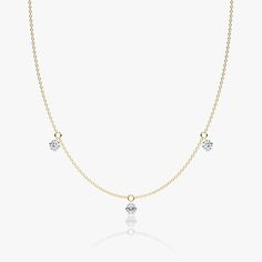 The Floating Station Necklace features a series of 0.25 or 0.50 carat Round Brilliant VRAI created diamonds that gently dangle from their pierced-diamond settings for effortless elegance and maximum scintillation. Customize your necklace in 14k solid yellow or white gold and choose 3 or 5 stones for a look that’s true to your everyday style. Classic Diamond Dangle Necklaces, Fine Jewelry Diamond Dangle Necklace With Accents, Anniversary Dangle Diamond Necklace, Diamond Dangle Necklace, Fine Jewelry Yellow Gold Lab Grown Diamond Necklace, Floating Necklace, Station Necklace, Diamond Settings, Accessories Jewelry Necklace