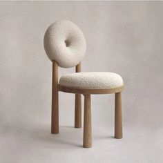 a chair made out of sheep's wool with a round seat and back rest