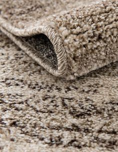 a close up view of a carpet with brown and white colors