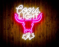 a neon sign that says coors light with a bull's head on it