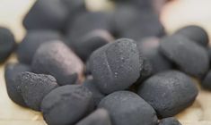 some black rocks sitting on top of a wooden table