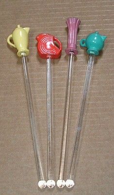 four different colored candy lollipops sitting next to each other on a table